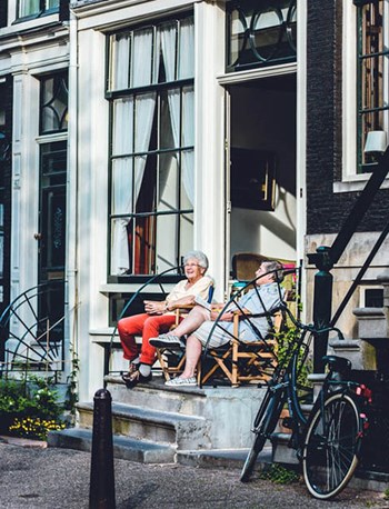 Locals sit outside in the sun