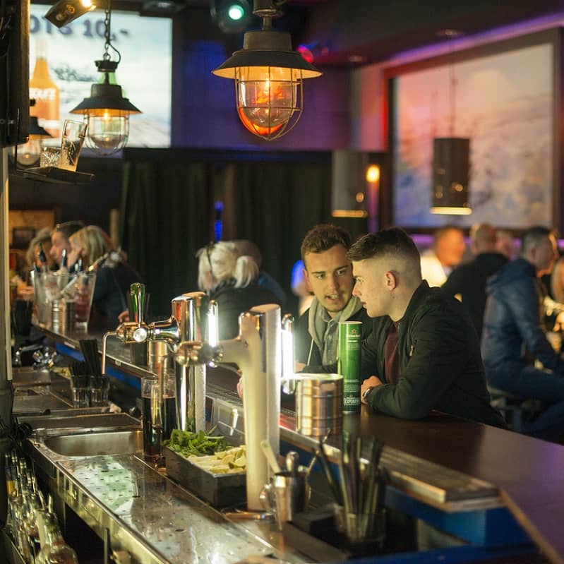 Combi Amsterdam Icebar guys sitting in the warm part of the bar with other people on the background