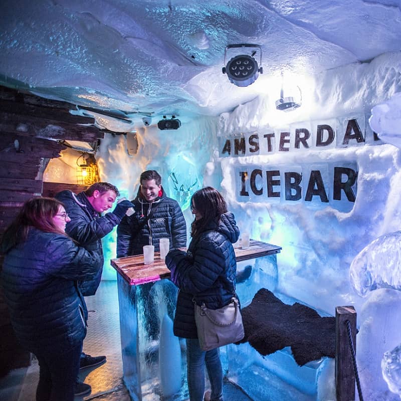 Combi Amsterdam Icebar group of friends having some drinks from glasses made of ice